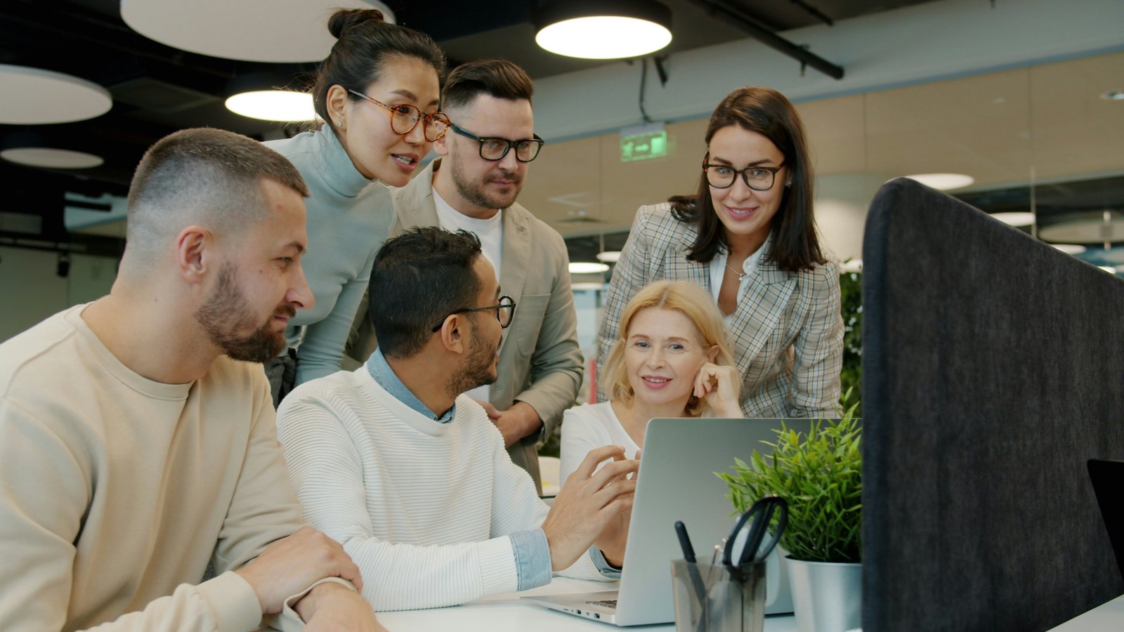 The RDX ecosystem: strategy, engineering, and training working as one team Team gathered around a laptop working through a project together